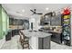 Open kitchen with a granite island, stainless steel appliances, and custom dark wood cabinetry at 2127 Brewer Ave, North Las Vegas, NV 89081