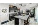Modern kitchen featuring a large island with seating, dark cabinets, and a view into the living room at 2127 Brewer Ave, North Las Vegas, NV 89081
