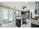 Kitchen featuring a granite island, modern appliances, and a view of the backyard through sliding doors at 2127 Brewer Ave, North Las Vegas, NV 89081