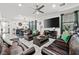 Open-concept living room with tile floors, comfortable seating, and access to the dining area at 2127 Brewer Ave, North Las Vegas, NV 89081