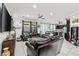 Spacious living room with recessed lighting, ceiling fan, and tile flooring flowing into the kitchen at 2127 Brewer Ave, North Las Vegas, NV 89081