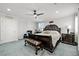 Spacious main bedroom featuring carpet, ceiling fan, windows for natural light, a bed, and a nightstand at 2127 Brewer Ave, North Las Vegas, NV 89081