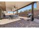 Outdoor patio with a large covered seating area, ceiling fans, and grilling station at 2127 Brewer Ave, North Las Vegas, NV 89081