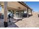 Large covered patio with ceiling fans, a built-in outdoor kitchen, and ample seating at 2127 Brewer Ave, North Las Vegas, NV 89081