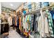 Walk in closet with clothing hanging from the rods and clear containers along the shelves at 2127 Brewer Ave, North Las Vegas, NV 89081
