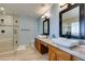 Bright bathroom with double sinks, a glass-enclosed shower, and a well-lit vanity area at 2246 Almart Cir, Henderson, NV 89014