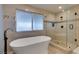 Luxurious bathroom featuring a soaking tub, a glass enclosed shower, and modern fixtures at 2246 Almart Cir, Henderson, NV 89014