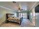 Spacious bedroom with a king-sized bed, a ceiling fan, and access to the backyard through French doors at 2246 Almart Cir, Henderson, NV 89014