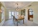 Inviting dining room features a wooden table, French doors and unique chandelier at 2246 Almart Cir, Henderson, NV 89014