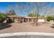 Charming brick home with a well-maintained gravel yard and mature trees in front at 2246 Almart Cir, Henderson, NV 89014