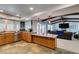 Charming kitchen with granite counters and stainless appliances flowing into the living area at 2246 Almart Cir, Henderson, NV 89014
