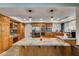 Charming kitchen with granite counters, oak cabinets, and pendant lighting at 2246 Almart Cir, Henderson, NV 89014