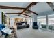Bright living room with dark wood beams, fireplace, backyard views and comfortable seating at 2246 Almart Cir, Henderson, NV 89014