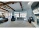 Bright living room features exposed wood beams, stone fireplace, and backyard access at 2246 Almart Cir, Henderson, NV 89014
