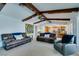 Spacious living room featuring exposed wood beams, plush seating, and ample natural light at 2246 Almart Cir, Henderson, NV 89014