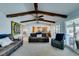 Spacious living room featuring exposed beams, backyard views, fireplace, and comfortable seating at 2246 Almart Cir, Henderson, NV 89014