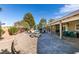 Wide angle of the expansive patio featuring lounge chairs, dining set, and a scenic backyard view at 2246 Almart Cir, Henderson, NV 89014