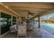 Inviting covered patio featuring stone flooring and stylish wicker furniture with pool view at 2246 Almart Cir, Henderson, NV 89014
