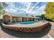 Backyard oasis featuring a sparkling pool, spacious patio, and manicured landscaping at 2246 Almart Cir, Henderson, NV 89014