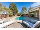 Backyard pool area showcasing a luxurious lounge area, sparkling pool water, and beautiful landscaping on a sunny day at 2246 Almart Cir, Henderson, NV 89014