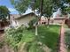 The backyard showcases a well-maintained lawn, mature trees, and a cozy patio area at 228 Hiawatha Way, Mesquite, NV 89027