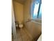 Cozy half-bathroom with toilet, towel rack, and a window that provides natural light at 228 Hiawatha Way, Mesquite, NV 89027