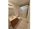 Bathroom featuring a shower over bath, single sink vanity, and tiled floor at 228 Hiawatha Way, Mesquite, NV 89027