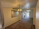 Spacious dining area featuring modern chandelier, adjacent to the living room at 228 Hiawatha Way, Mesquite, NV 89027