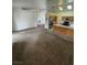 Spacious living room boasts neutral carpeting and an open layout connected to the kitchen at 228 Hiawatha Way, Mesquite, NV 89027