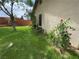 Landscaped yard features green grass, roses and a tree, enhancing the curb appeal of the property at 228 Hiawatha Way, Mesquite, NV 89027