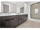 Modern bathroom with double vanity, sleek dark cabinets, and a frameless glass shower for a spa-like experience at 253 Robledo St, Las Vegas, NV 89138