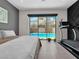 Bedroom featuring a view of the sparkling pool and backyard through a large sliding glass door, complete with a treadmill at 253 Robledo St, Las Vegas, NV 89138