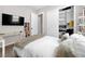 Inviting bedroom with sliding closet doors and a wall-mounted television for entertainment and convenience at 253 Robledo St, Las Vegas, NV 89138