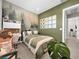 Stylish bedroom with a white bedframe, olive green accents, and a forest-themed wall in this modern home at 253 Robledo St, Las Vegas, NV 89138