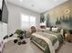 Cozy bedroom featuring a nature-themed mural, comfortable bed, and stylish decor at 253 Robledo St, Las Vegas, NV 89138