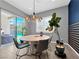 Bright dining area with modern light fixture, view of the pool, and a stylish accent wall at 253 Robledo St, Las Vegas, NV 89138