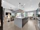 Open-concept kitchen with marble countertops, island seating, and seamless flow to the living room at 253 Robledo St, Las Vegas, NV 89138
