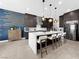 Stylish kitchen featuring a large island with seating, modern lighting, and stainless steel appliances at 253 Robledo St, Las Vegas, NV 89138