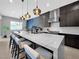 Contemporary kitchen with a large quartz island, bar seating, and pendant lighting at 253 Robledo St, Las Vegas, NV 89138