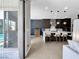Contemporary kitchen showcasing an island with seating, dark wood cabinets, and modern pendant lighting at 253 Robledo St, Las Vegas, NV 89138