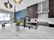 Stylish kitchen boasts marble countertops, a stainless steel stove, and a unique blue accent wall at 253 Robledo St, Las Vegas, NV 89138