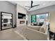 Modern living room featuring a fireplace, a large TV, a stylish ceiling fan, and sliding glass doors at 253 Robledo St, Las Vegas, NV 89138