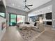 Open-concept living area with a fireplace, backyard pool access, and a kitchen featuring a large island at 253 Robledo St, Las Vegas, NV 89138
