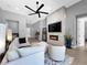 Cozy living room featuring a modern fireplace, flat screen TV, and tile flooring at 253 Robledo St, Las Vegas, NV 89138