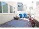 Charming backyard features modern bricks, two large garbage cans, and a bicycle at 2678 Weathered Copper Ave, North Las Vegas, NV 89086