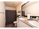 Bathroom featuring double sinks, granite countertop, white cabinets, and bath at 2678 Weathered Copper Ave, North Las Vegas, NV 89086