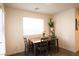 Cozy dining area featuring natural light and a table with seating for four at 2678 Weathered Copper Ave, North Las Vegas, NV 89086