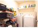 Functional laundry room equipped with a washer, dryer, and ample storage at 2678 Weathered Copper Ave, North Las Vegas, NV 89086