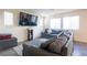 Comfortable living room with ample natural light and a large sectional sofa at 2678 Weathered Copper Ave, North Las Vegas, NV 89086