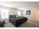 Spacious main bedroom featuring two windows and a neutral color palette at 2678 Weathered Copper Ave, North Las Vegas, NV 89086